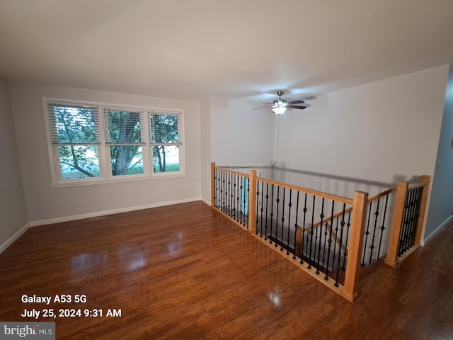 unfurnished room with dark hardwood / wood-style flooring and ceiling fan