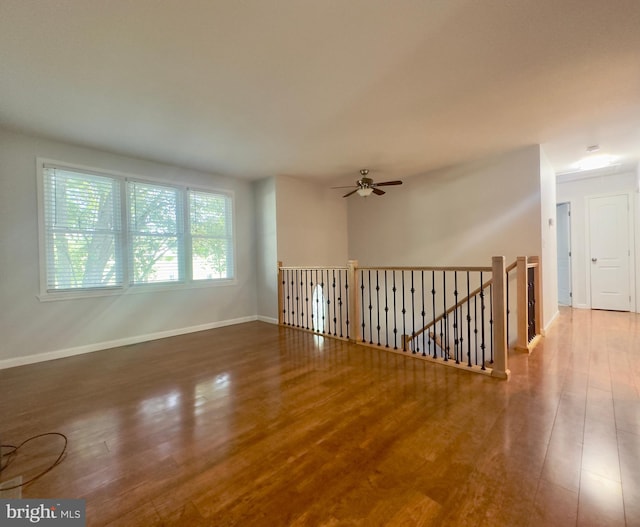 empty room with wood-type flooring and ceiling fan