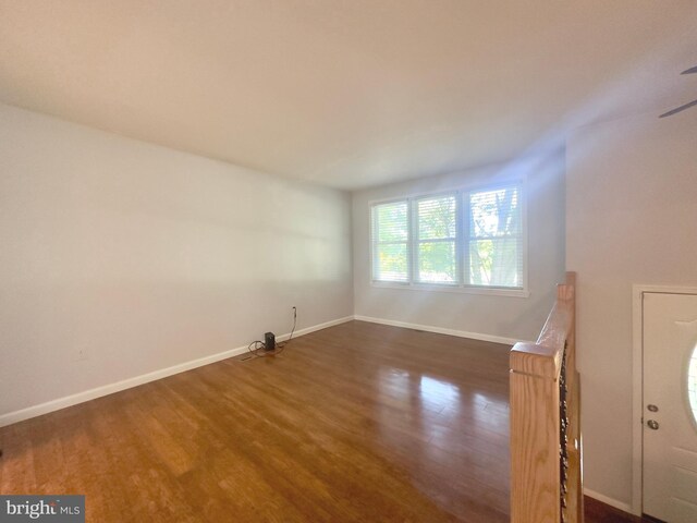 unfurnished room featuring dark wood-type flooring