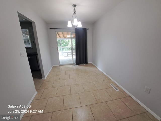 unfurnished dining area with light tile patterned floors and a chandelier