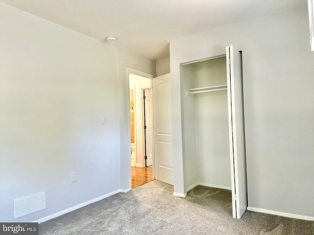 unfurnished bedroom featuring a closet and carpet flooring