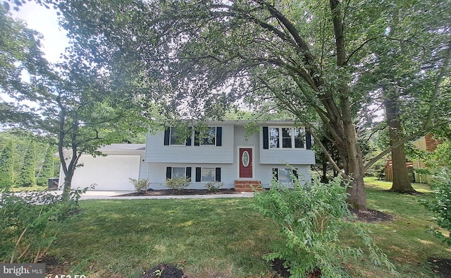 split foyer home with a garage and a front lawn