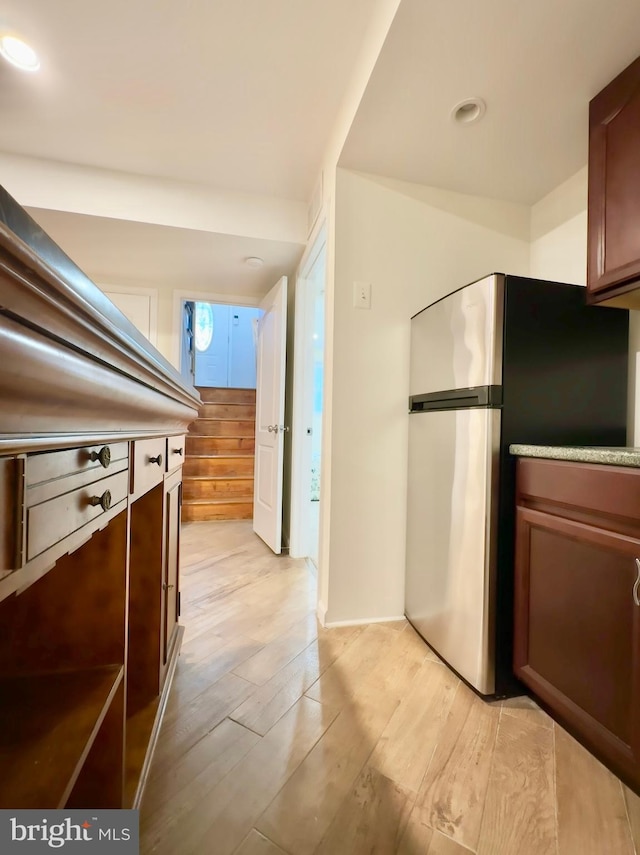 kitchen featuring light hardwood / wood-style flooring and stainless steel refrigerator