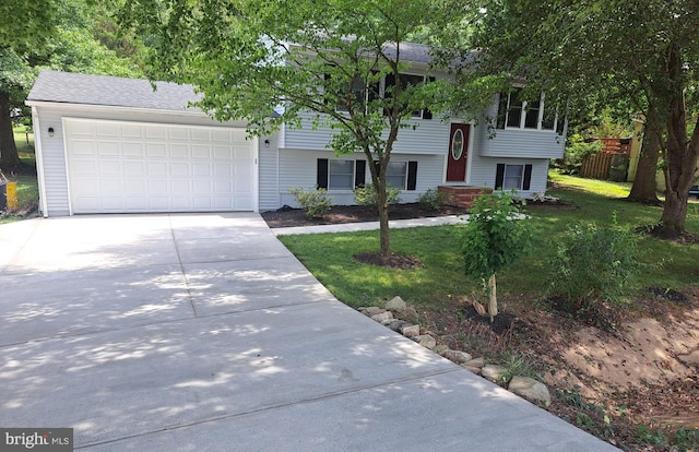 bi-level home with a garage and a front yard