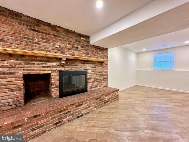 unfurnished living room featuring hardwood / wood-style flooring and a fireplace