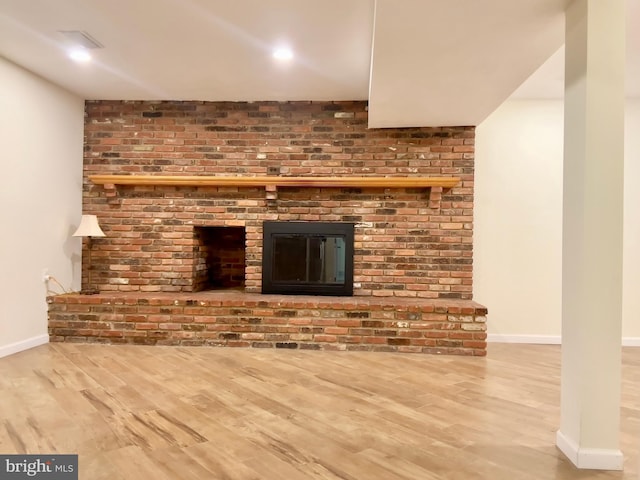 unfurnished living room featuring hardwood / wood-style flooring and a fireplace