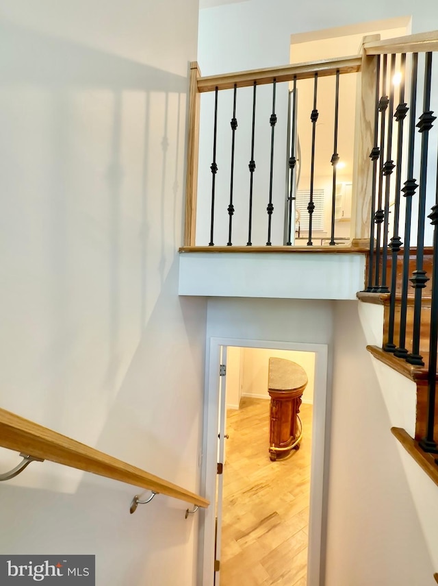 stairs featuring hardwood / wood-style floors