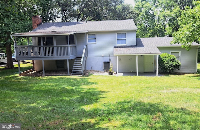 back of house with a patio, a lawn, and central air condition unit