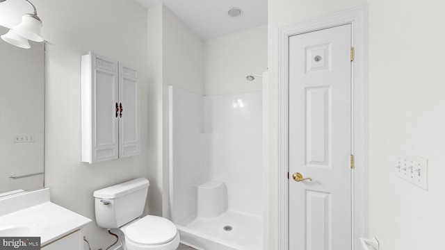 bathroom with toilet, vanity, and walk in shower