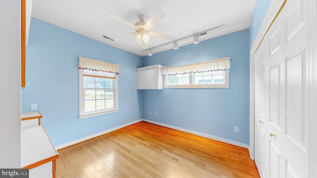 unfurnished bedroom featuring ceiling fan, light hardwood / wood-style flooring, and a closet