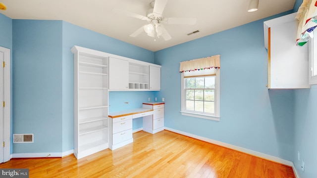 interior space featuring ceiling fan, light hardwood / wood-style floors, and built in desk