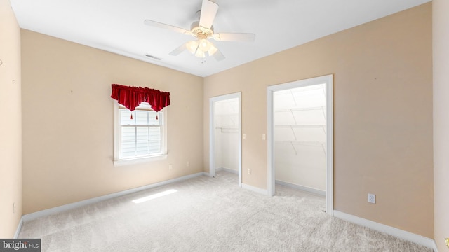 unfurnished bedroom with ceiling fan, a closet, and light colored carpet