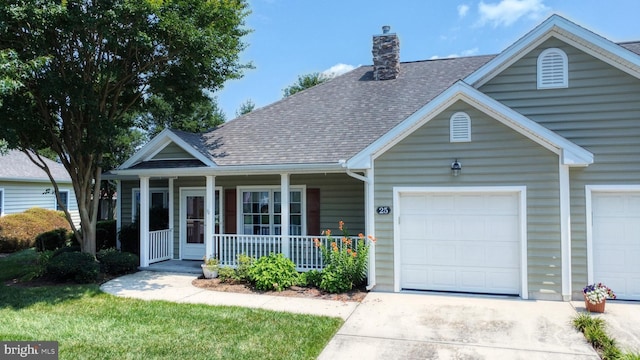 view of front of property with a porch and a garage