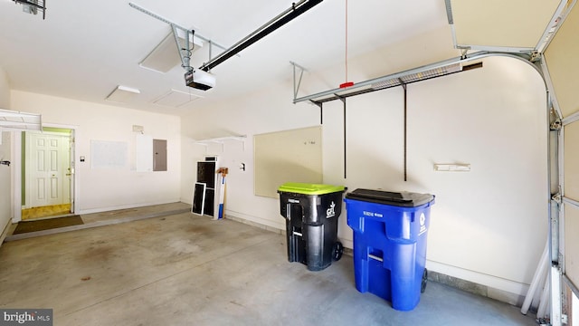 garage with a garage door opener and electric panel