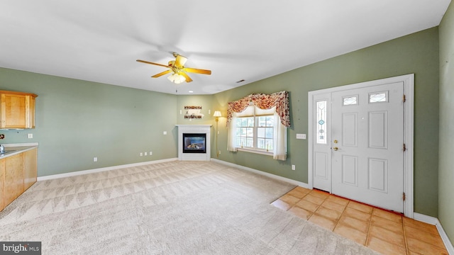 tiled entryway with ceiling fan