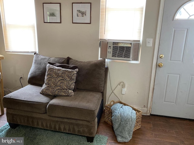 sitting room with cooling unit, hardwood / wood-style flooring, and a wealth of natural light