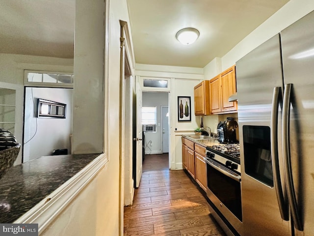 kitchen featuring hardwood / wood-style floors, appliances with stainless steel finishes, and sink