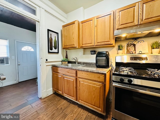 kitchen featuring wood-type flooring, cooling unit, sink, and stainless steel range with gas stovetop