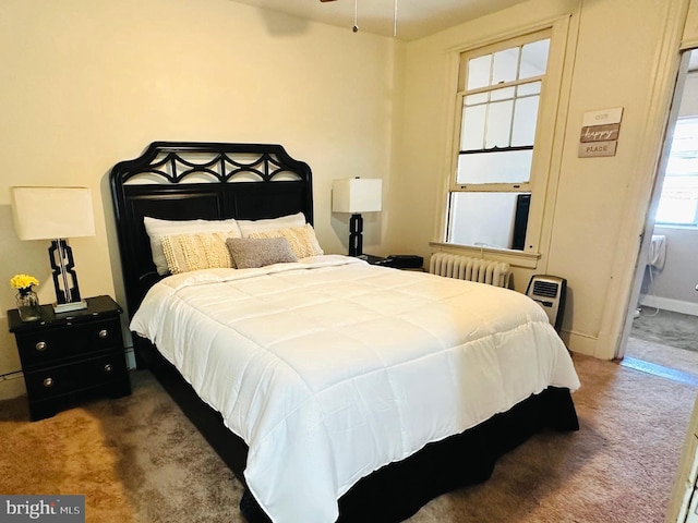 carpeted bedroom with radiator