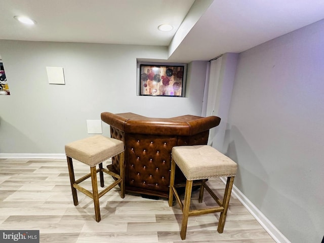 bar featuring light hardwood / wood-style flooring