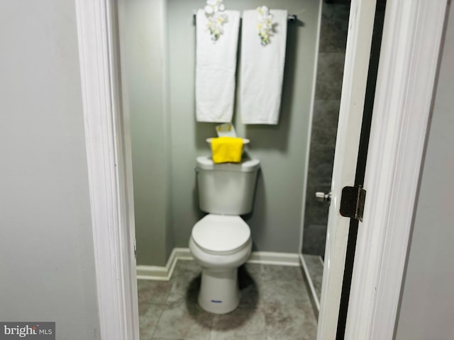 bathroom with tile patterned flooring and toilet