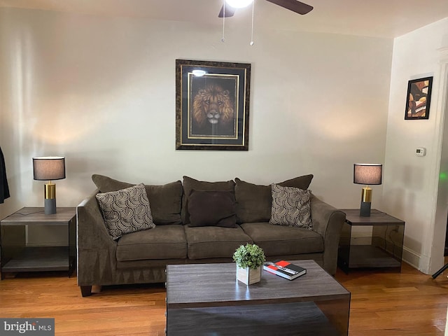 living room featuring wood-type flooring and ceiling fan