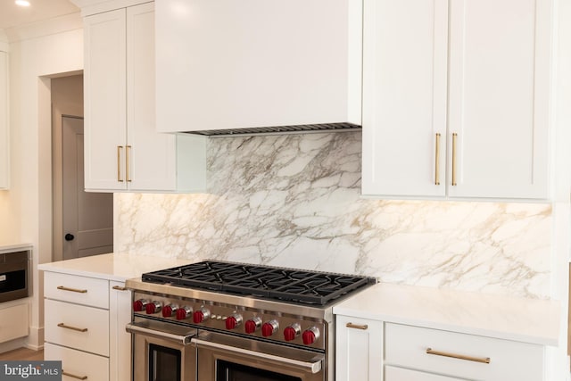 kitchen with decorative backsplash, white cabinetry, and double oven range