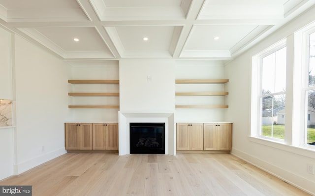 unfurnished living room with beamed ceiling, light hardwood / wood-style floors, crown molding, and coffered ceiling