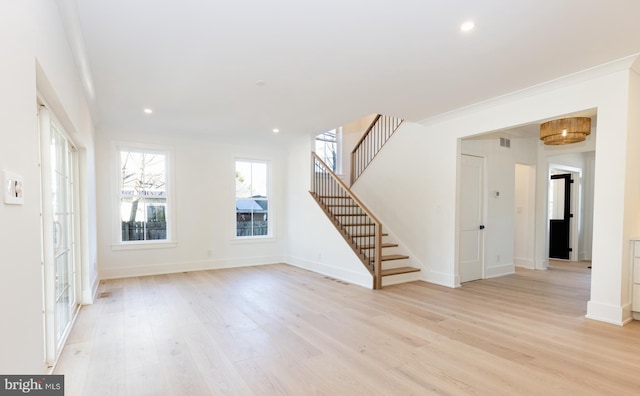 interior space with light hardwood / wood-style floors and ornamental molding