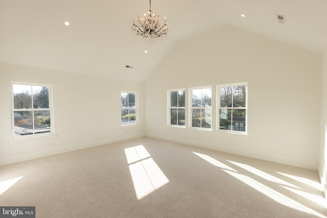 unfurnished room featuring light carpet, high vaulted ceiling, and a chandelier