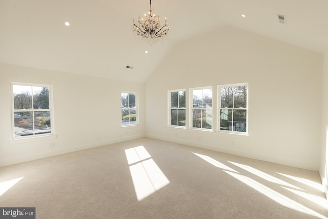 unfurnished room featuring light carpet, high vaulted ceiling, plenty of natural light, and a notable chandelier