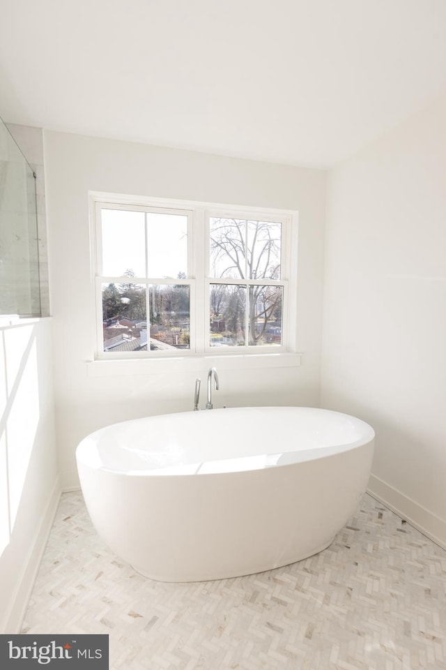 bathroom with a tub to relax in