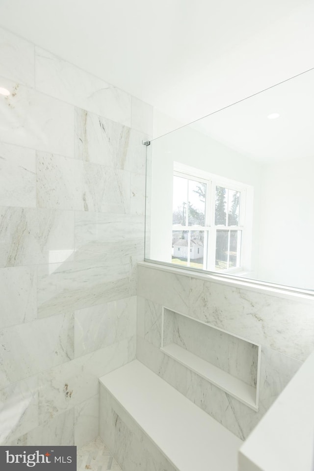 bathroom featuring tiled shower