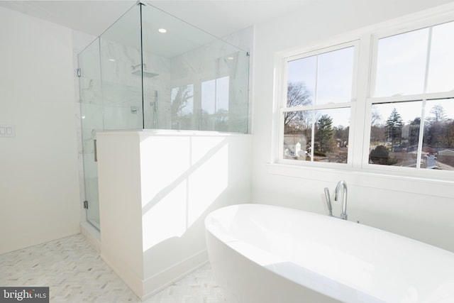 bathroom featuring separate shower and tub