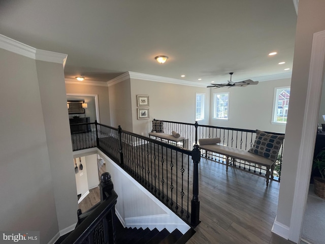 staircase featuring ceiling fan, wood-type flooring, and ornamental molding