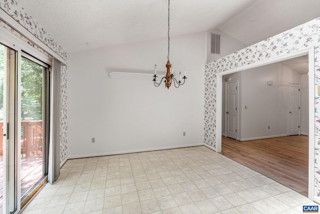 unfurnished room featuring a notable chandelier, light hardwood / wood-style flooring, a textured ceiling, and vaulted ceiling