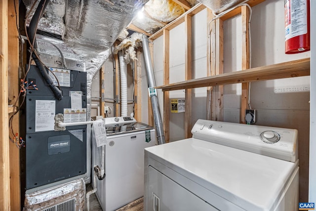 washroom featuring washer and clothes dryer and heating unit