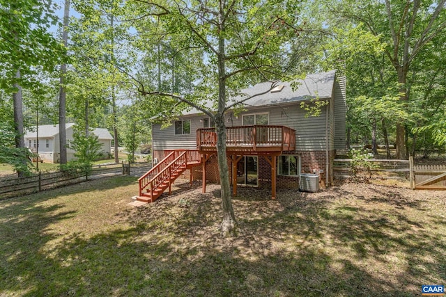 view of playground featuring a yard, central air condition unit, and a wooden deck