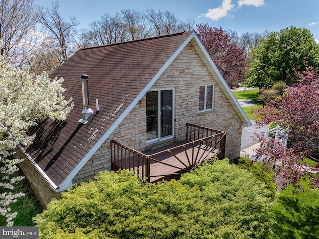 rear view of property with a wooden deck