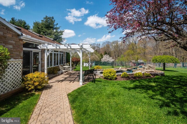 view of yard with a pergola and a patio