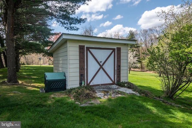 view of outbuilding featuring a lawn