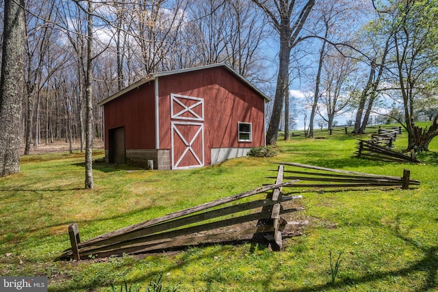 view of outdoor structure featuring a lawn and a rural view