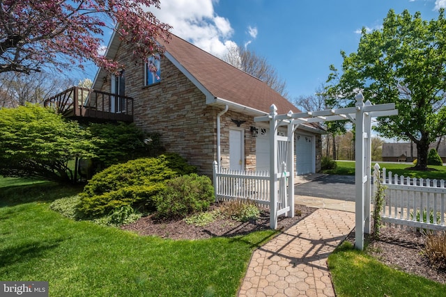 view of side of home featuring a yard and a pergola