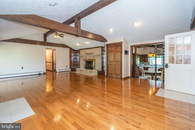 unfurnished living room featuring vaulted ceiling with beams, ceiling fan, light hardwood / wood-style flooring, and a baseboard heating unit