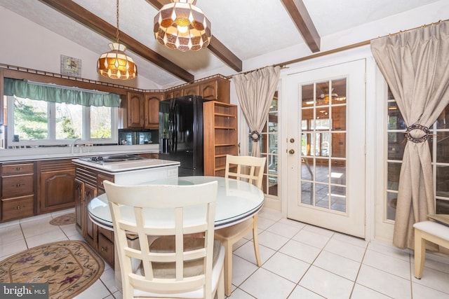 kitchen with vaulted ceiling with beams, sink, light tile patterned floors, a kitchen island, and black refrigerator with ice dispenser