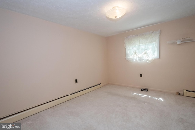 carpeted spare room with a baseboard radiator