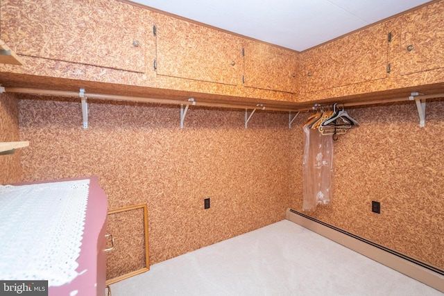 walk in closet featuring a baseboard heating unit