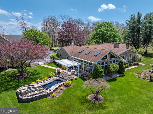 rear view of property with a pergola, a yard, and a patio