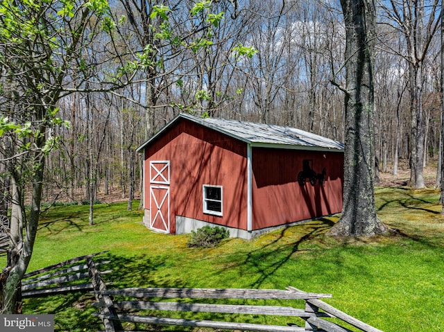 view of outbuilding featuring a lawn