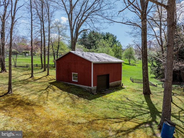 view of outbuilding featuring a garage and a yard